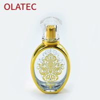 Nouveau flacon de parfum en verre de style moyen-oriental, plaqué or, atomiseur sculpté de manière complexe ; flacon d'huile essentielle avec vaporisateur
