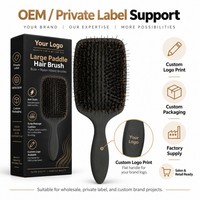 Brosse à perruque avec poils de sanglier et de nylon, design grand format en forme de pagaie et coussin en caoutchouc pour l'entretien des postiches, vente en gros
