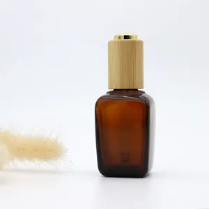Flacon compte-gouttes en verre d'huile essentielle carrée ambre de 30ml avec couvercle en bambou