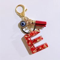 Porte-clés en résine avec initiale A-Z, paillettes dorées, coquille rouge, strass, breloque œil porte-bonheur et pompon rouge, pour femme, cadeau