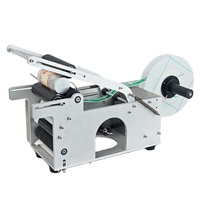 Étiqueteuse manuelle simple autocollant adhésif de bouteille ronde avec poignée étiqueteuse bouteille de vin petite machine d'emballage