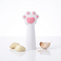 En gros, Éplucheur d'ail manuel en silicone Patte de chat, Outil de dépeluchage à rouleau pour la cuisine et le décortiqueur d'arachides