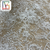 Tissu de dentelle de tulle perlé de luxe brodé à la main avec des perles et des sequins pour robe de soirée
