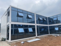 Villa conteneur préfabriquée modulaire portable de 20 pieds à assemblage rapide en panneaux sandwich d'acier contemporains pour bureau, hôtel ou bâtiment