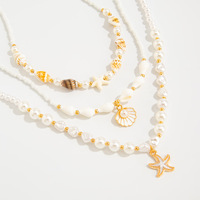Collier polyvalent de luxe léger, ton or, perles, design multi-couches, breloques en coquillage, chaînes mixtes, texture lisse