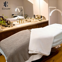 Lit de beauté électrique de luxe pour esthéticienne, base noire, lit facial incurvé, lit de massage spa, lit pour extensions de cils