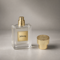 Tapa de perfume de lujo en aleación de zinc dorado pulido, cilíndrica de dos niveles con relieve en la parte superior, cubierta para botella con logotipo personalizado para botella de perfume.