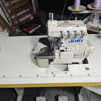 Machine à coudre surjeteuse d'occasion à bon prix JUKI MO-6704S à lit plat 3 fils