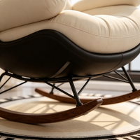 Fauteuil à bascule Egg Shell au design moderne, chaise longue en PU noir, tissu capitonné crème, support métallique double triangle