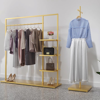 Présentoir mural haut de gamme en métal et acier inoxydable pour magasin de vêtements