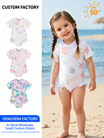Maillot de bain bébé une pièce à manches courtes, demi-zip, imprimé licorne et marguerites florales, jambes à volants, base lavande ton sur ton, pour l'été