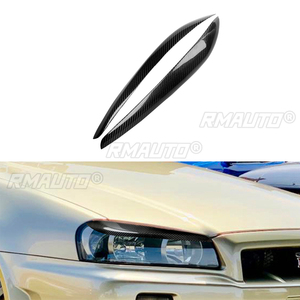 ฝาครอบตกแต่งไฟหน้ารถยนต์คาร์บอนไฟเบอร์แท้ 1 คู่ สำหรับ Nissan Skyline R34 ปี 1999 2000 2001 2002 อุปกรณ์ตกแต่งรถยนต์ - Product Image 1