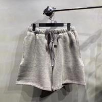 Shorts de survêtement essentiels en coton pour hommes, couleur avoine clair, avec lettres imprimées en flocage noir – Vente directe usine 2026