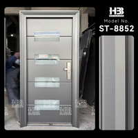 Porte extérieure de sécurité en acier inoxydable isolée avec 4 panneaux de verre insérés pour l'entrée principale d'une maison moderne américaine