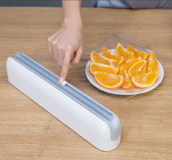 Nouveau Design Cuisine Cling Film Cutter Ustensiles de cuisine Cling Wrap Avec Slide Cutter. Boîtes d'emballage alimentaire en plastique de qualité alimentaire pour la cuisine