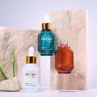 Ensemble d'emballages de luxe pour soins de la peau : flacons ronds en verre pour sérum avec compte-gouttes et pipette, logo personnalisable pour les soins du visage et des cheveux