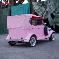 Roadster électrique de style antique avec capote blanche et phares doubles pour les balades en bord de mer et les promenades dans les parcs