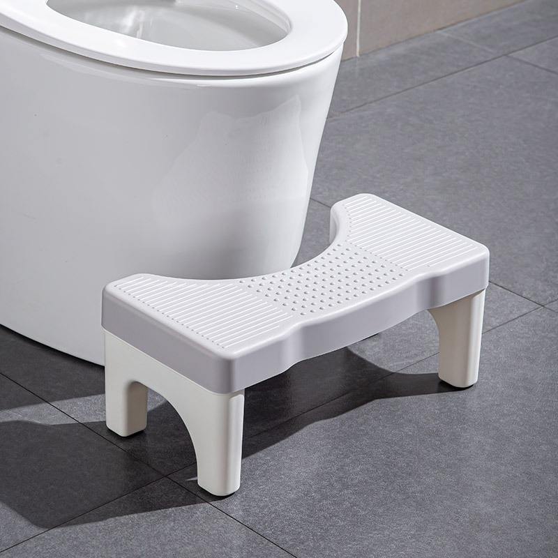 The stool has a gray surface and white feet.