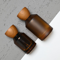 Botol silinder kaca parfum kelas atas 50ml 100ml, botol kaca Amber, tutup kayu bentuk segitiga