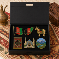 Lot de cadeaux personnalisés en gros : Épingles à revers émaillées Afghanistan (drapeau noir, rouge, vert, tapis, cheval) et badges souvenirs touristiques, présentés en coffret cadeau
