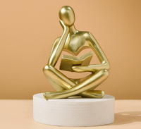 Sculpture abstraite moderne en résine Art Déco, représentant une figure humaine assise tenant un livre, pour la décoration de la maison