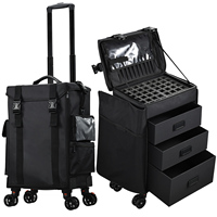 Valise de maquillage professionnelle noire à roulettes avec compartiment supérieur amovible 2 en 1, en nylon, avec roulettes
