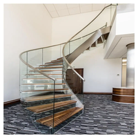 Escalier courbé en métal style américain populaire avec marches en bois massif noyer pour intérieur