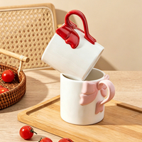 Tasse en céramique avec anse en forme de nœud, blanche brillante, avec ruban rose, rouge, bleu, pour café ou thé, cadeau, logo personnalisé, vente en gros d'usine