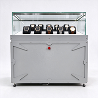 Vitrine de présentation de montres en métal gris avec dessus en verre industriel, éclairage LED, bouton rouge, CE ETL pour magasin de montres