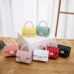 Mini monederos de nuevo diseño, mini bolso de mano de gelatina de lujo, monederos y bolsos de mano para mujer, bolsos cruzados para niños y señoras con asa de perla