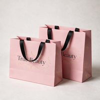 Sacs en papier personnalisés de luxe avec votre propre logo pour vêtements, sacs d'emballage pour boutique de vêtements rose mat avec poignées en ruban