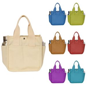Sac fourre-tout en toile beige avec poches latérales pour bouteille d'eau et bouton-pression pour le bureau, les pique-niques et le transport de repas bento - Product Image 1
