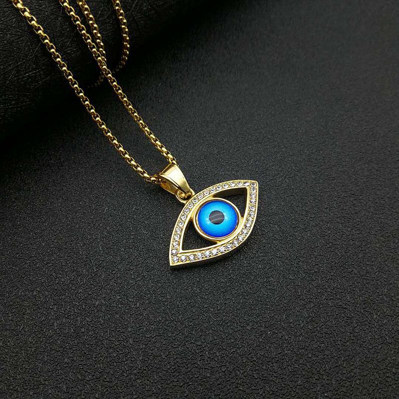 Grand pendentif unique doré aux yeux bleus