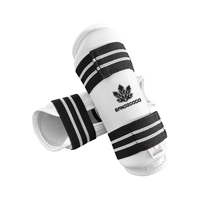 Protège-tibias de Taekwondo en mousse PU avec sangle élastique réglable pour l'entraînement et le sparring, personnalisables avec logo pour clubs et dojos, commande en gros