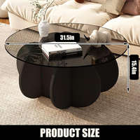 Table basse ronde moderne avec plateau en verre et base en pétales noirs pour salon