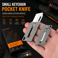 Couteau utilitaire mini en alliage de titane OEM de qualité supérieure, ouverture par gravité, coupe-boîte de poche, porte-clés, lame 3Cr13, mini logo personnalisé, vente en gros