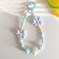 Lanière perlée Macaron Arc-en-ciel avec nœud papillon et breloque fleur rose pour femmes et filles, pendentif de sac en perles acryliques pastel