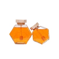 Tarro de miel único con cuchara de madera, tarro de vidrio hexagonal al por mayor para miel