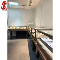 Table de présentation de bijoux en métal noir de luxe avec vitrine en verre moderne, éclairage LED et tiroir verrouillable pour boutique de détail