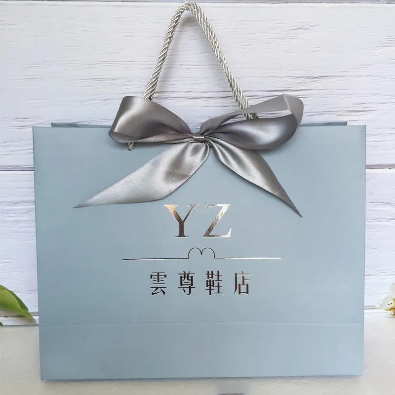 Bolsa de papel de lujo con logotipo personalizado para mujer, zapatos de ropa, regalo de cosméticos, bolsa de papel de compras con cinta de lazo, gran oferta