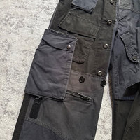 Pantalon cargo multi-poches en patchwork noir pour homme, poches à rabat utilitaires, ourlet zippé, coupe décontractée, pantalon cargo robuste de style streetwear
