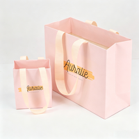 Fournisseur de sacs en papier pliables de luxe personnalisés avec poignées en ruban, pour la promotion de la mode, les cadeaux, les cosmétiques et les parfums, couleur rose