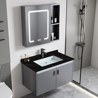Ensemble de salle de bain moderne de luxe léger en aluminium avec vasque en céramique grise en pierre frittée, miroir LED et armoire murale pour hôtel et villa