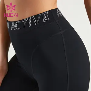 HUCAI OEM logo personalizzato a vita alta per il controllo della pancia sport con strass alfabeto cintura leggings da ginnastica pantaloni da yoga per le donne