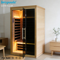 Sauna infrarouge lointain moderne pour 2 personnes en bois de pruche avec contrôle intelligent Wi-Fi et verre noir pour la relaxation, le spa et le bien-être à domicile