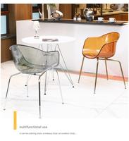 Chaise de salle à manger moderne en acrylique intégré transparent ambre, avec accoudoirs incurvés et dossier ergonomique, design coquille, pour la maison et le bureau