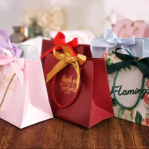 Bolsa de regalo de papel de embalaje rosa con logotipo personalizado de lujo a precio de fábrica para fiesta de boda con asa y bolsa de regalo con cinta