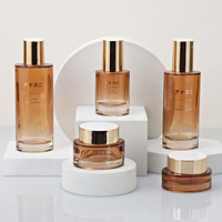Nouveau Style luxueux ovale fond épais cristal bouteille cosmétique en verre personnalisé couvercle ambre translucide peut être personnalisé or mat