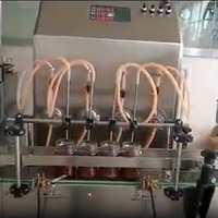 Machine de remplissage de pots de miel à 4 têtes, machine de remplissage et de bouchage automatique de haute précision pour huile médicale en verre numérique