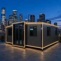 Maison conteneur extensible et respirante avec bandes lumineuses LED, ailes pliables gris foncé pour villa urbaine sur toit et immeuble de bureaux